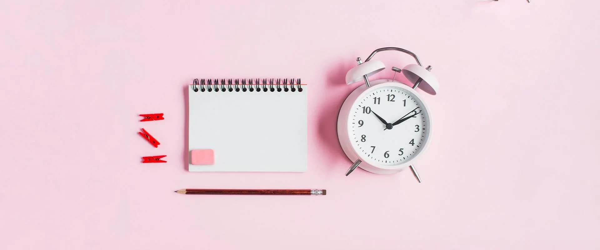 Alarm clock with calendar on pink background - Image for post: The rise of the time tracking app for remote work